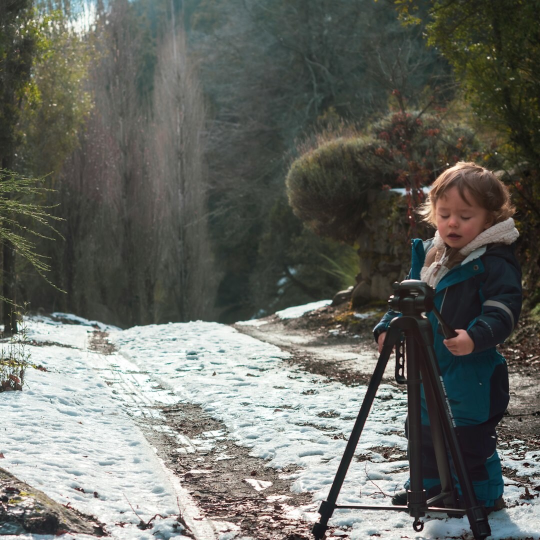 Technician setting up a camera on a tripod outdoors